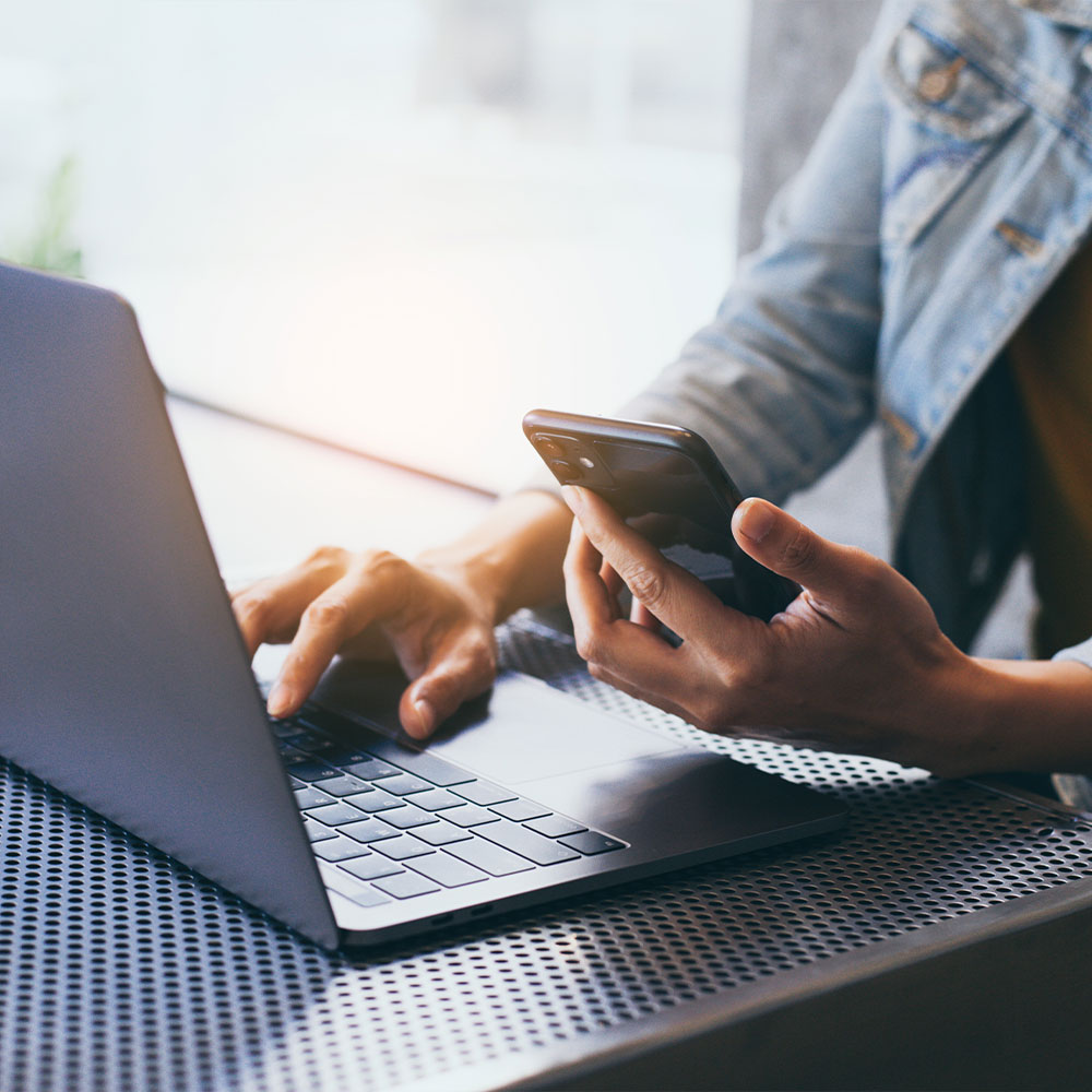 The image shows a modern office space with a sleek desk, chair, and computer setup, featuring wood paneling, a white countertop, and a contemporary design.